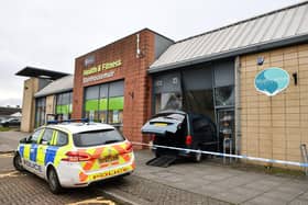Police attended after the car crashed into the former Strathcarron Hospice shop in Stenhousemuir (Picture: Michael Gillen, National World)