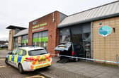 Police attended after the car crashed into the former Strathcarron Hospice shop in Stenhousemuir (Picture: Michael Gillen, National World)