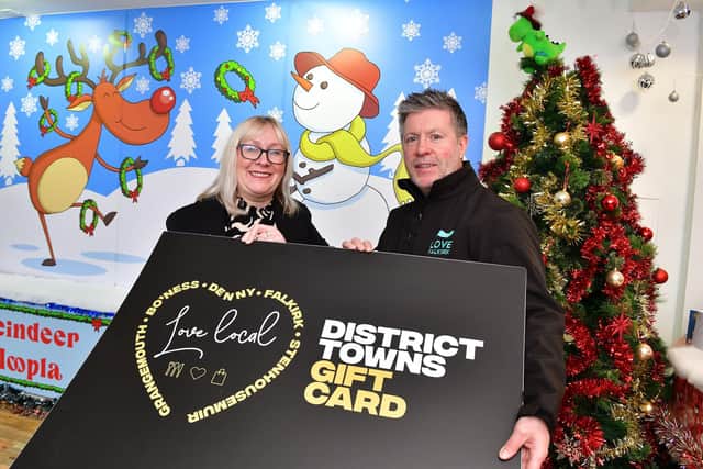 Andrew McNinch, from Falkirk Vineyard Church, received Falkirk District gift cards from Elaine Grant of Falkirk Delivers to be given to children without gifts this Christmas.  (Pic: Michael Gillen)