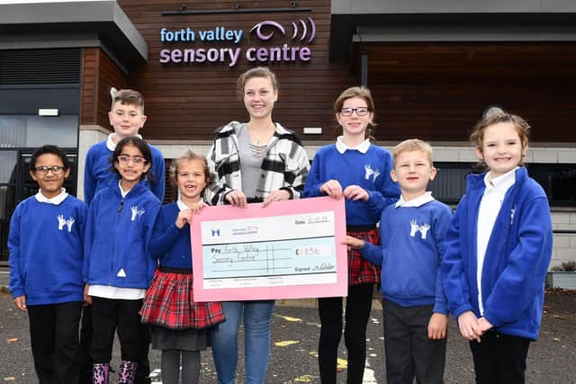 Pupils from Windsor Park School handing over cheque for £1856 to Rowan Ferguson, Forth Valley Sensory Centre community fundraiser on behalf of school staff who had taken part in the Kiltwalk. Pic: Michael Gillen