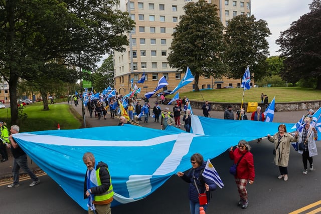 Some of the marchers helped carry a large Saltire.