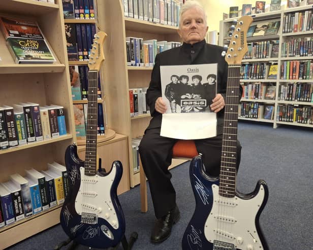 Falkirk councillor Billy Buchanan is selling signed Oasis guitars for a good cause  Pic: Contributed