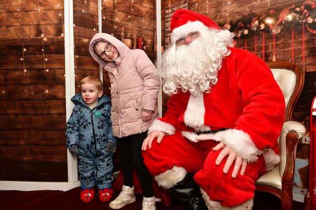Skye Leigh Price, 9, and Marc Junior Penman, 2 met Santa when the mobile grotto stopped at Antonine Primary in Bonnybridge last week.  (Pic: Michael Gillen)