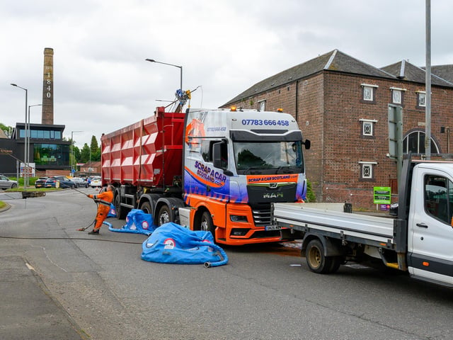 Workers securing the vehicle.