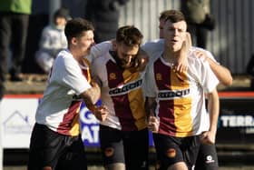 Grant Hamilton is mobbed by his Whitburn team-mates after scoring a late winner against Camelon Juniors on Saturday in the East of Scotland first division (Pictures by Kristopher Dowell)