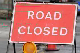 The road has been closed while the fallen trees are cleared.