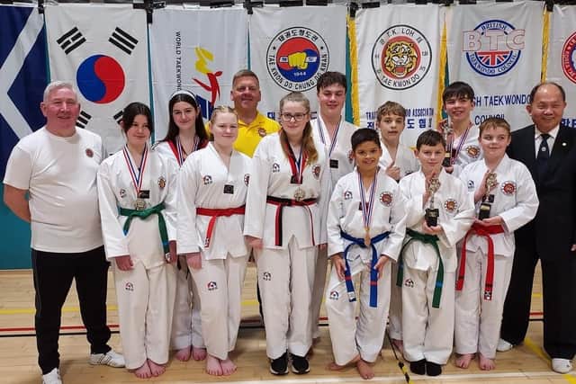Chief instructor Duncan Irvine (1st left) with his medal-winning students, referee William Ferguson and Grandmaster TK Loh, the head of the TTA