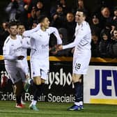 Jaze Kabia celebrates with team-mates after opening scoring during 3-0 win in Alloa in February (Pic Michael Gillen)