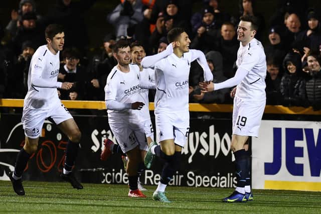 Jaze Kabia celebrates with team-mates after opening scoring during 3-0 win in Alloa in February (Pic Michael Gillen)