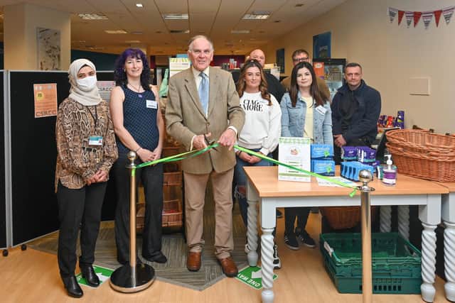 Pat Reid does the honours to declare the Howgate Centre's new community pantry open
