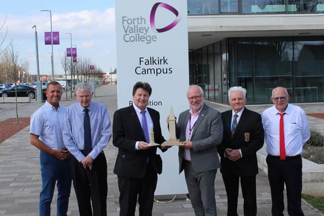 Forth Valley College print 3D modell of Baiinsford War Memoiral - Robert Bissett holding the model with Professor Ken Thomson along with Kevin Beattie, James Irvine, James Marshall from the Bainsford War Memorial Association.