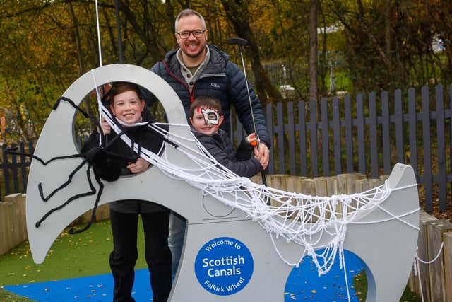 Mark Sutherland with sons Jack, 12, and Tom, 8, from Larbert take on a spookily decorated mini golf course.