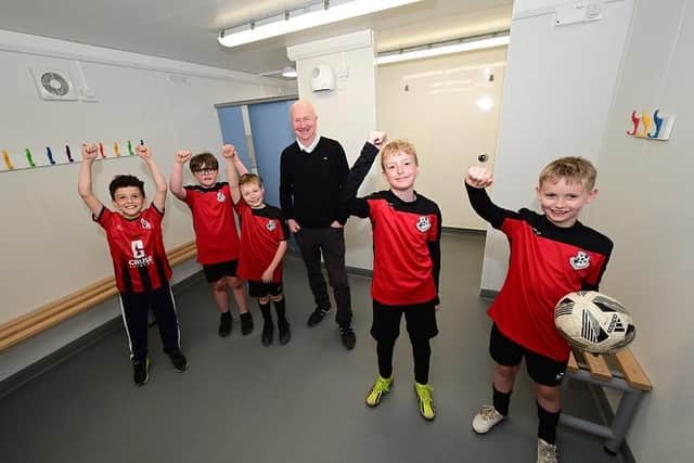 Councillor Paul Garner inside the new pavilion at Anderson Park with players from Bonnybridge Youth Football Club. Pic: Falkirk Council