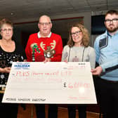 Thomas Horn handing over a cheque for £6000 to Plus Forth Valley CEO Susan Fullarton. Pic: Michael Gillen