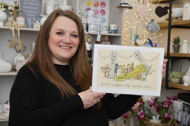 Vikki Betty, owner of With love, Vikki x, with the specially created Star Wars themed print for the Bo'ness Fair by illustrator The Grey Earl.  (Pic: Michael Gillen)