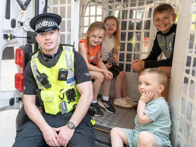 Sitting in the back of a police van.