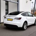 The Tesla was photographed parked next to the school with a charging cable running through a window into the school building - despite the fact there were charging points just yards away in the car park (Picture: Michael Gillen, National Word)