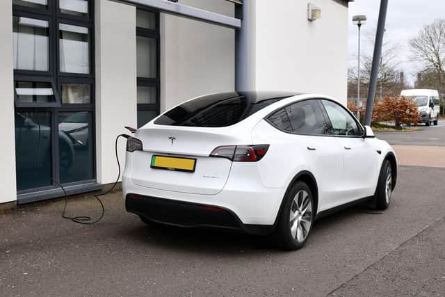 The Tesla was photographed parked next to the school with a charging cable running through a window into the school building - despite the fact there were charging points just yards away in the car park (Picture: Michael Gillen, National Word)