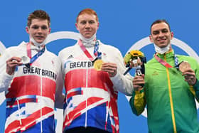 Tom Dean, right, with Duncan Scott on the podium after the the final of the men's 200m freestyle swimming event