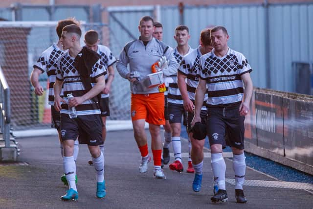 Shire players exit the pitch at full time