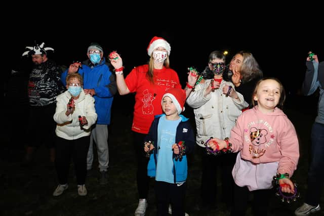 Lauren Sinclair (red T-shirt), founder of the Worldwide Santa's Christmas Eve Jingle Facebook page, took part in the event with family, friends and neighbours. Picture: Michael Gillen.