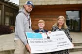 Jason Murray and son Cory, 9, hand over a cheque for £910 to Strathcarron Hospice community campaign coordinator Marion Blaney.(Picture: Michael Gillen)