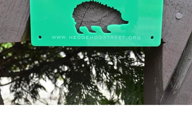 Signs reminding people to allow the space to remain for hedgehogs
