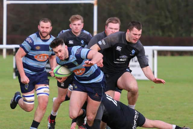 Connor Faulds is hauled down by two chasing Berwick players