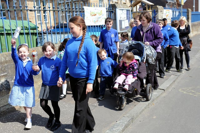 Waving their Olympic torches.