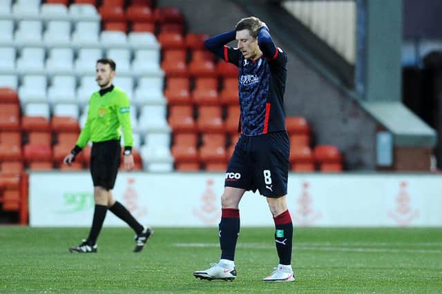 Blair Alston looks to the ground after Airdrie's second goal consigns Falkirk to another year in League One. Picture: Michael Gillen