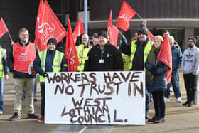 Workers made their feelings clear as they formed a picket line outside council headquarters. (Pic: Stuart Vance)