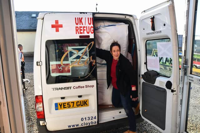 Carolanne Cowan, Cloybank supervisor, squeezes the final donations into the minibus that will travel to Poland