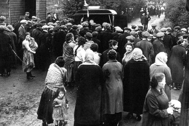 Redding pit disaster, crowds gather at the pithead. The new memorial will include a mother and child as pictured on the left of the picture.