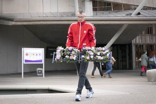 Peter Krykant lays a wreath depicting 1,935 - the number of overdose deaths in Scotland during a ceremony to mark International Overdose Awareness Day outside the Scottish Parliament. Picture: Jane Barlow/PA Wire