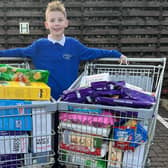 Aaron Clark, who runs his own business The Kandy Kid, raised enough money from a raffle to buy two large trolleys of food to donate to the Kersiebank Community Project's Foodbank.  (Pic: Submitted)