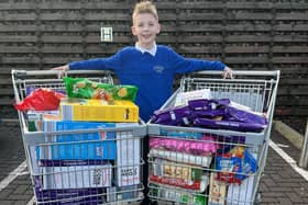 Aaron Clark, who runs his own business The Kandy Kid, raised enough money from a raffle to buy two large trolleys of food to donate to the Kersiebank Community Project's Foodbank.  (Pic: Submitted)