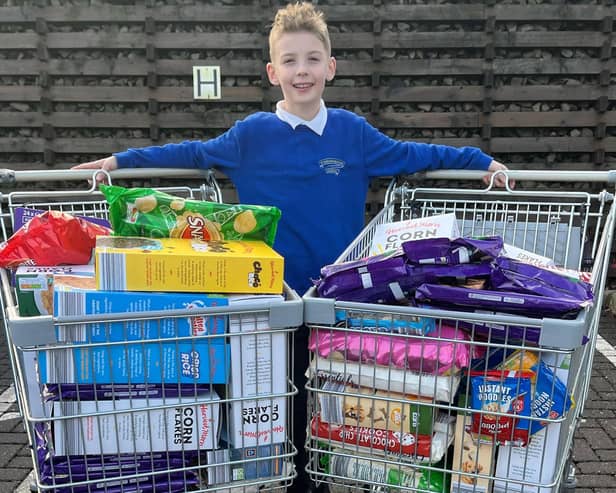 Aaron Clark, who runs his own business The Kandy Kid, raised enough money from a raffle to buy two large trolleys of food to donate to the Kersiebank Community Project's Foodbank.  (Pic: Submitted)