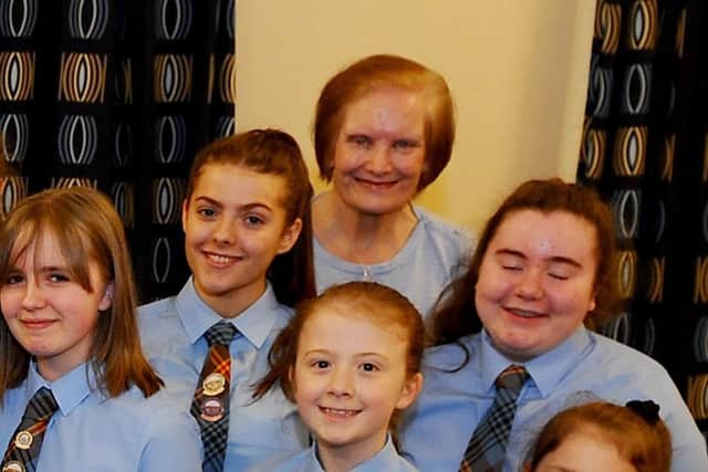 Mary Ann Brown pictured with the choir in 2019