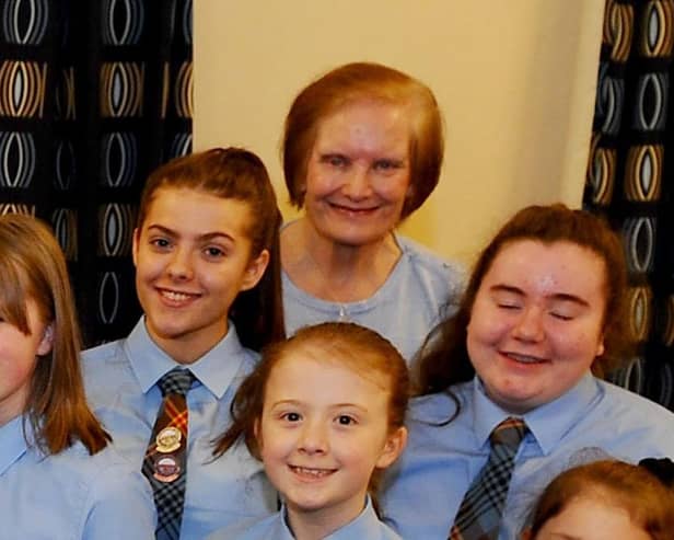Mary Ann Brown pictured with the choir in 2019