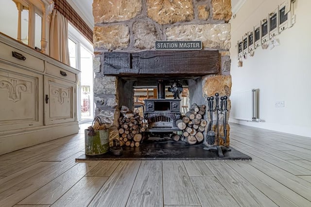 The family snug features a log burner with sandstone chimney, which helps separate the room.