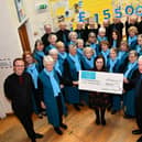 Strathcarron Singers presenting a cheque for £8000 to Strathcarron Hospice taking the total they have raised for the hospice to £155,000 since the choir was formed in 2005.