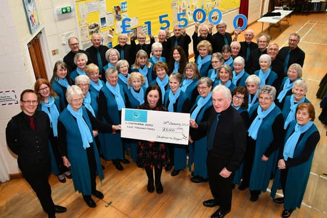 Strathcarron Singers presenting a cheque for £8000 to Strathcarron Hospice taking the total they have raised for the hospice to £155,000 since the choir was formed in 2005.