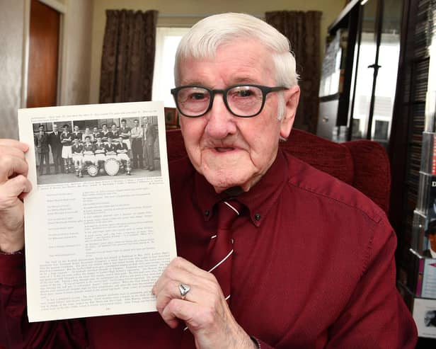 Willie Russell, now 84, with a photograph of the successful Larbert High School team he played in. Pic: Michael Gillen