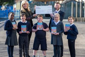 Local Taylor Wimpey Sales Executive Calum MacLean with Mrs Aileen McLean Depute Teacher and members of the P5 Eco Group at Queensferry Primary School celebrating their donation of £250 and Ecotastic Activity books.