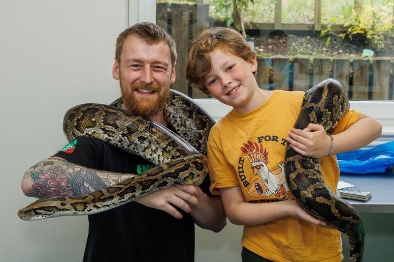 Sebastian Abendroth is pictured with George Struthers (Racks 4 Reptiles) and snake Larry.