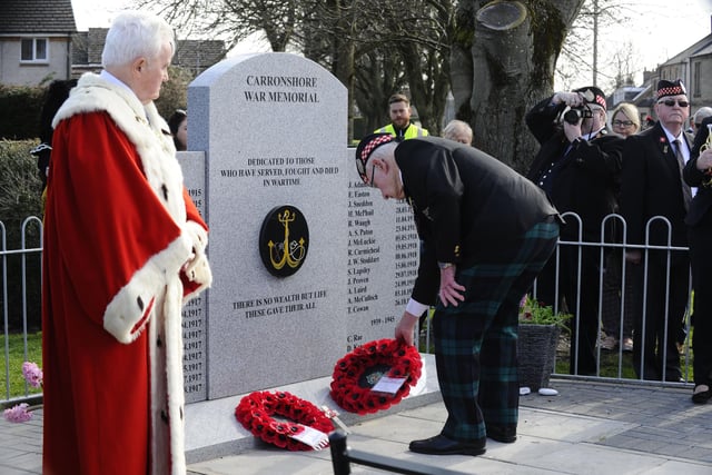 A former soldier lays a wreath