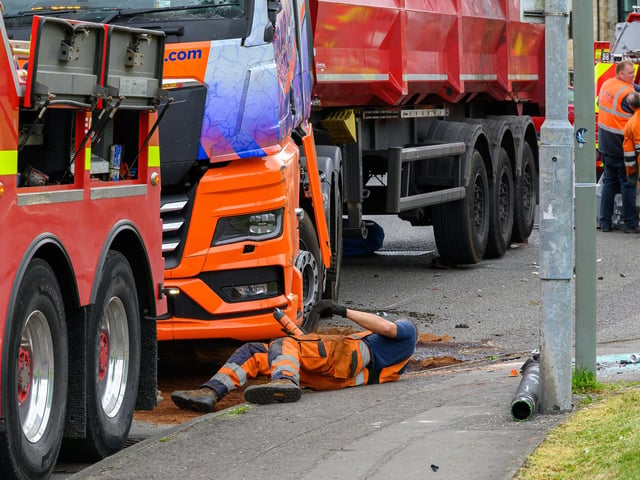 A workman secures the vehicle.