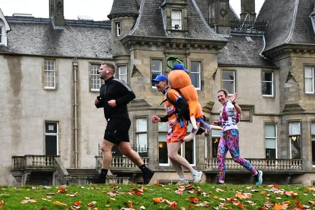 Craig Russell and Kevin the Carrot run past Callendar House