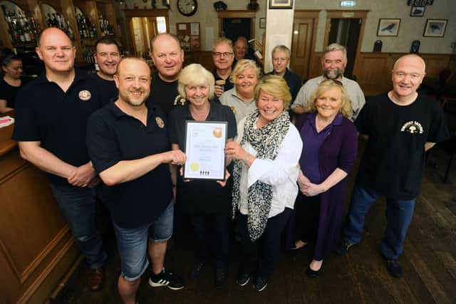 Corbie owner Gail Fairholm accepts the Forth Valley CAMRA Pub of the Year certificate from (centre left) CAMRA branch chair Stuart Batchelor. Michelle Thomson MSP was also in attendance for the presentation.  (Picture: Alan Murray)