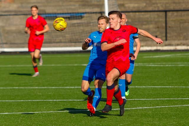 Goalscorer Danny Galbraith looks to steal possession